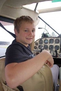 Fuqua School student Jon Spencer poses in an airplane cockpit before flying over Farmville with local pilot Morgan Dunnavant while preparing for take off.