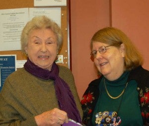 WCF President Deborah McClintock, right, presents a check to Norma Williams of the Commonwealth Chorale. 