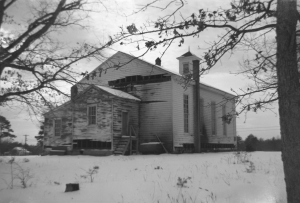 Mercy Seat Baptist Church just after the Dec. 8, 1962, fire. The missing siding was removed by Hampden-Sydney firemen so that water could be applied to the flames. When the building was repaired, the brick chimney on the right was removed and a basement was dug under the building.
