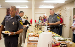 CARSON REEHER | HERALD Officers Jake Wolford, right, and Clint Thackston collect food from the buffet breakfast provided by Cedar Baptist Church.