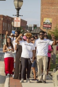 CARSON REEHER | HERALD Hakeem Croom, left, and Karima ElMadany lead the peace walk down Main Street from First Baptist Church to the Moton Museum.