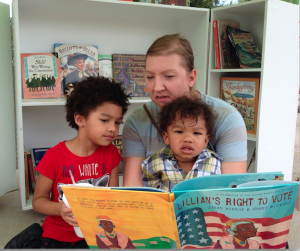 Three book-cart guests read “Lillian’s Right to Vote.” 