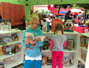 Children read politically-themed books from the mobile book cart.