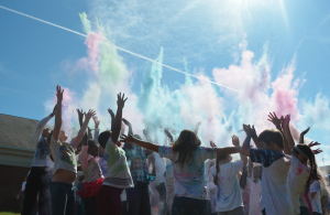 EMILY OVERSTREET A group of Cumberland County Elementary School students throw colored powder into the air during the Fun Run.