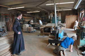 JORDAN MILES | HERALD Father Steven Reuter looks on as crews perform woodworking activities on the ground floor of the seminary building.