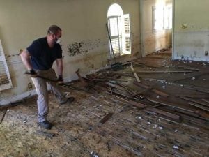 The Kinex team assisted two homeowners whose homes were flooded in Nichols, S.C. Here, Andrew Lonadier removes flooring damaged by flood waters.